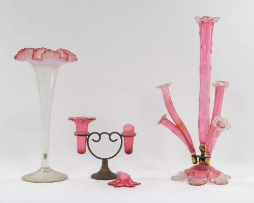 A group of Victorian and later glass, comprising a cranberry and opaline glass trumpet vase, 32cm high, a flared rim cranberry glass vase, 29cm high, and a cranberry glass four branch epergne, with two sided stand and metal base. (3, AF)