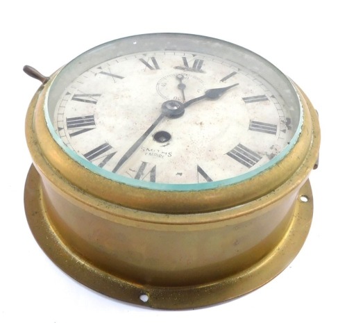 A Smith's Empire brass wall clock, with Roman numeric dial, subsidiary seconds dial, 18cm diameter.