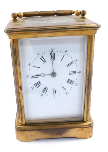 An early 20thC brass cased carriage timepiece, with white enamel dial bearing Roman and Arabic numerals, win barrel movement with coil strike, the case of conventional form, 13cm high, 10cm wide, 8cm deep.