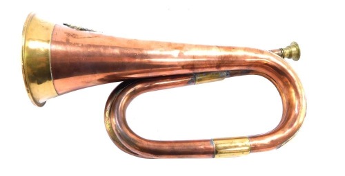 An early 20thC military copper and brass bugle, with applied swan crest for the Western Australian University Regiment, 30cm wide.