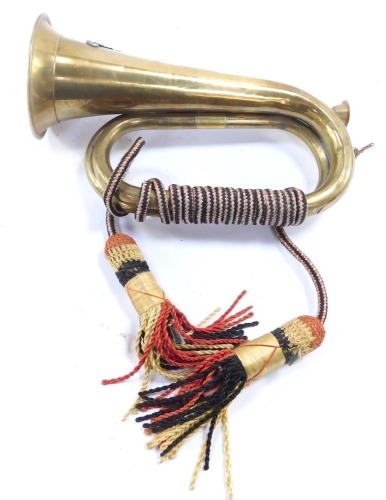 An early 20thC military copper and brass bugle, with Royal Artillery crest, 27cm wide.