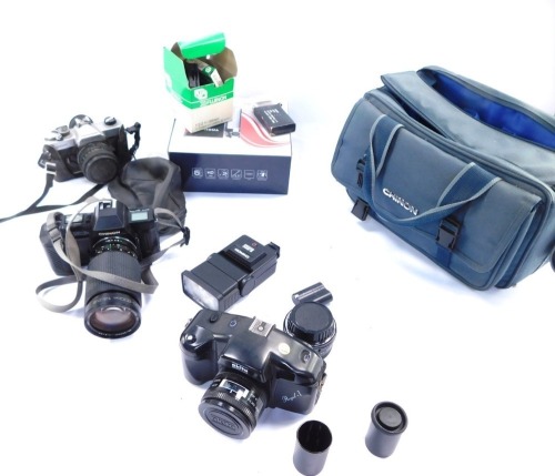 A group of camera equipment, comprising an Akita Royal I camera, Chinon CP - 7M camera, with a Chinon Zoom 1-5.6 lens, a Fujitca STX I, various lens caps, Toshiba charger, etc. (a quantity)