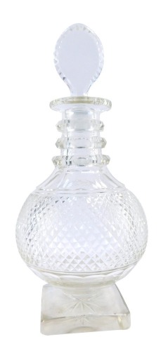 A Georgian style cut glass decanter, with a bull's eye stopper, of baluster form with a three ring collar, on a square star set base, 33cm high. (AF)