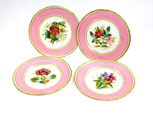 A set of four late 19thC porcelain dessert plates, each with gilt border with cream banding and pink border, with central painted floral decoration.