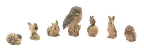 Seven Poole Pottery animal figures, comprising large owl, 22cm high, three rabbits, small owl, mouse on an apple, and a bird. (7)