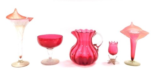 A group of cranberry glass, to include a cranberry glass jug, two Jack in the pulpit vases, sweetmeat dish, etc, the largest piece 28cm high. (5)
