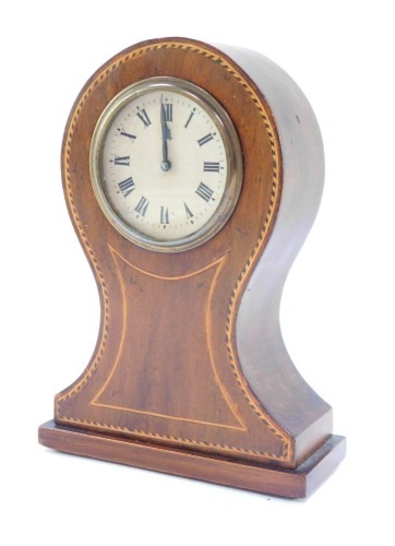 An Edwardian mahogany and line inlaid mantel clock, the circular dial bearing Roman numerals, clockwork movement by the Hamburg American Clock Co, with integral key, the case of balloon form, 15cm high, 11cm wide.