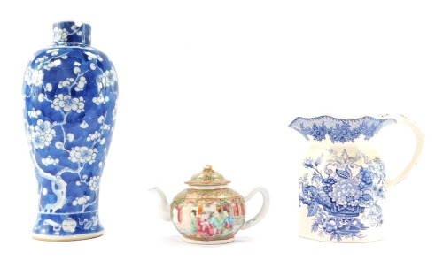 Three ceramic items, comprising a Chinese blue and white porcelain vase decorated with prunus blossom against a cracked ice ground, four character mark to base (AF), 30cm high, a Cantonese famille rose porcelain teapot and cover decorated with reserves of
