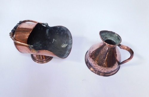 A copper helmet shaped coal scuttle, with turned ebonised handle, 32cm high, and a copper two&nbsp;gallon flagon. (2)