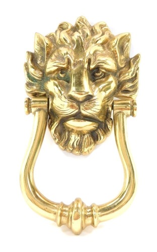 A 19thC brass door knocker, formed with a lion mask handle, 23cm high.