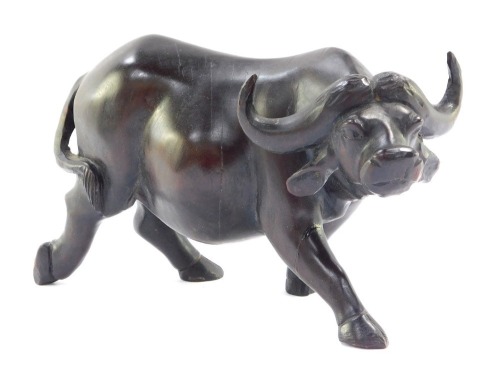 An Eastern carved wooden figure of a buffalo, 15cm high.