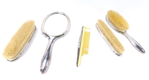 A Swiss Jetzler mid Century dressing table set, comprising three brushes, comb and hand mirror, each monogrammed M J, white metal stamped 800 Jetzler.