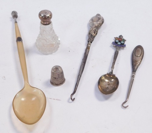 A group of small silver, comprising an Edward VII cut glass pepperette with silver lid, Birmingham 1907, thimble, two button hooks, Scottish horn spoon with white metal collar and thistle terminal, and a George V silver and enamel commemorative tea spoon 