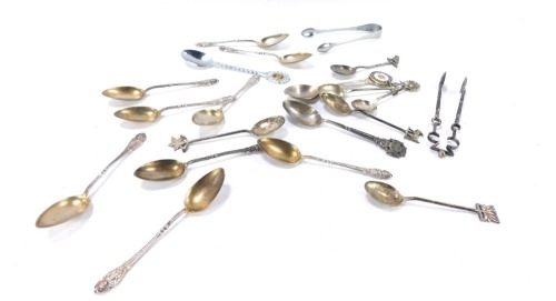 A group of silver and silver plated spoons, comprising a set of nine Continental and gilt spoons, each with Greek goddess figure, white metal stamped 800, 2&frac12;oz, a pair of George V silver sugar nips with a crested three leaf clover top, &frac12;oz, together with 