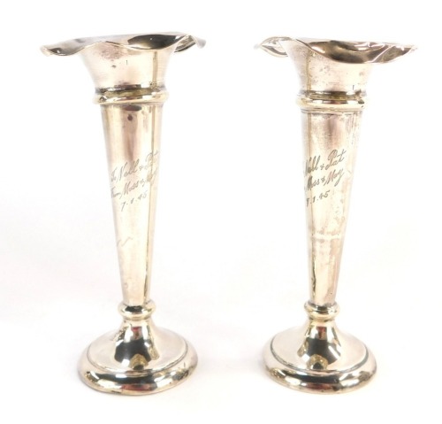 A pair of Edward VII loaded silver bud vases, each with a flared rim, one bearing the inscription To Nell And Pat From Moss And Madge 7.1.45, Birmingham 1908, 14cm high, 6&frac34;oz gross.