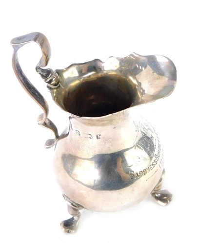 An Edward VII silver cream jug, of baluster form, presentation engraved 'To A.H. from Baroness Burdett Coutts 1905', raised on three cabriole legs, Birmingham 1901, 2&frac12;oz.