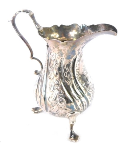 A George III silver cream jug, with embossed rococo floral and foliate decoration, vacant shield reserve, maker's mark worn, London 1807.