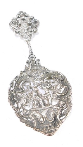 A Victorian silver sweetmeat spoon, repousse decorated with a mask and foliate scroll terminal, the heart shaped bowl with a seated semi clad figure, cupids and foliate scrolls, William Comyns & Sons, London 1892, 1&frac12;oz.