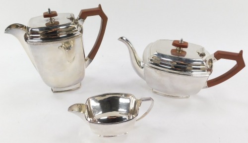 An EPNS three piece silver plated tea service, with brown handle and knop, ribbed border, maker S&W.
