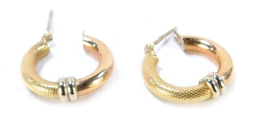 A pair of tri-colour hoop earrings, each in a loop with gold hammered design, rose gold plain design and a white gold two hooped centre, with clip on backs, yellow metal feint markings believed to be 9ct, 1.5cm high, 2.4g all in.