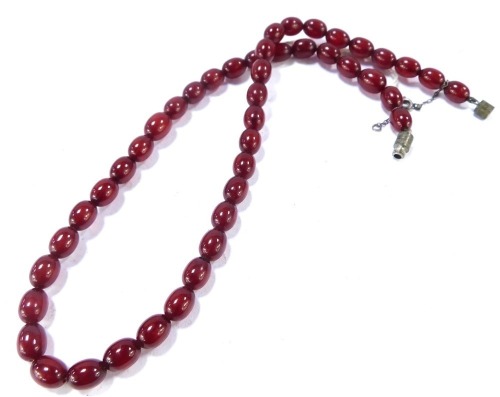 A red amber necklace, with oblong beads, 1cm wide, the chain 42cm long, on a silver plated clasp, 15.9g all in.