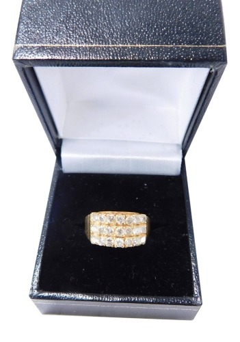 A gentleman's diamond set signet ring, with three rows of seven diamonds, on an alternating and tiered setting, with stepped shoulders, yellow metal stamped 18k, size N, 6.4g all in, boxed.