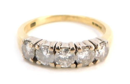 An 18ct gold diamond five stone dress ring, set with five round brilliant cut stones, each approx 0.25cts, totalling approx 1.25cts overall, in four claw white gold setting, on a yellow metal band, size Q&frac12;, 4.8g all in, boxed.