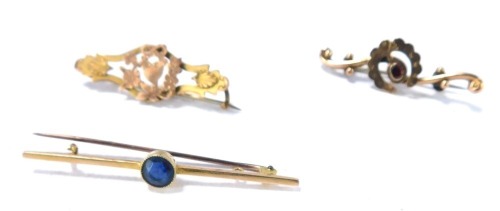 Three bar brooches, comprising a 15ct gold bar brooch, set with central sapphire, 5.5cm wide, a horseshoe garnet set bar brooch, 4cm wide, and a Victorian Sweetheart brooch, 4cm wide, 6.2g all in. (3)