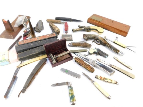 A group of novelty penknives, pistols and razors, to include bone handled and horn handled knives, Rolls Razors, linch pistol lighters, etc. (a quantity)