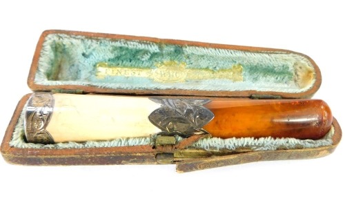 A Victorian amber cheroot holder, with silver mounts, amber cheroot and bakelite top with foliate scroll detail, Chester 1878, in WHC Finest Quality fitted box.
