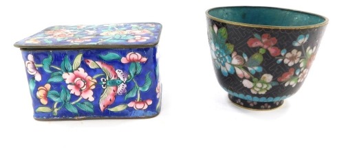 A late 19thC Chinese cloisonne box and cover, of oblong form, set with flowers against a blue ground, 5cm high, 9cm wide, 6cm deep, and a cloisonne tea bowl. (2)