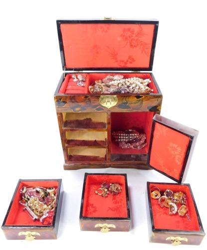 An Eastern hardwood jewellery box and contents, the jewellery box with single panel door with cork design to include contents of necklaces, bracelets, earrings, silver bar brooch, etc. (a quantity)