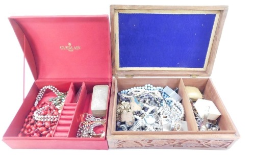 Two jewellery boxes and contents, comprising a carved wooden leaf bordered jewellery box and contents, of faux pearl necklaces, dress watches, butterfly brooches, etc., together with a red material dome topped jewellery box, comprising bracelets, paste st