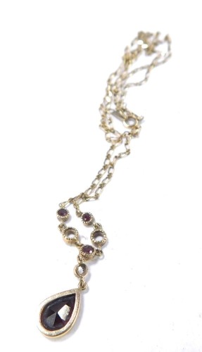 A garnet set neck chain, of graduated form with tear drop and five stone set links, yellow metal stamped 9k, 3g all in, 40cm long.
