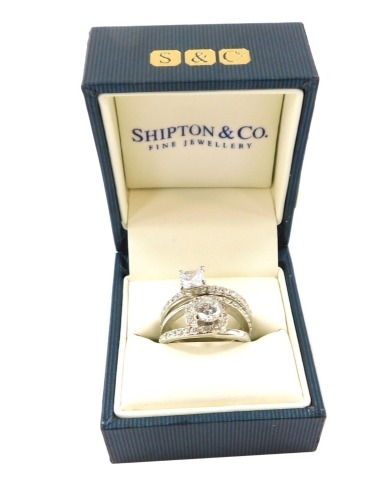 Two dress rings, set with paste stones in white metal, stamped 925, size O, in Shipton & Co box. (2)