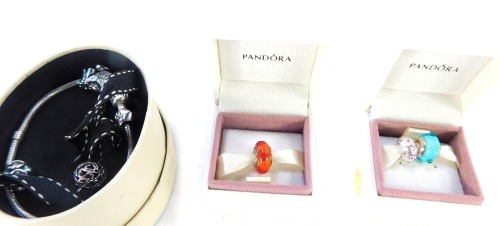 A Pandora charm bracelet and various charms, to include love heart, angel, love heart drop, one coloured bead and a love link coloured bead, and a further imitation Pandora charm and others. (a quantity)