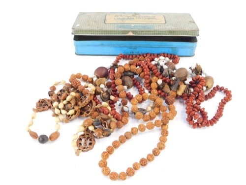 An Adaptorplast vintage First Aid tin, and a group of beaded nut necklaces. (a quantity)