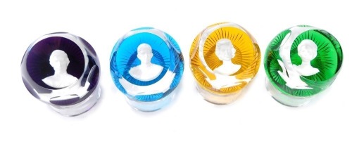 A set of four Baccarat Royal Family paperweights, comprising the Prince of Wales in purple, The Duke Of Edinburgh in blue, Queen Elizabeth II in yellow, and the Princess Anne in green, each with presentation stand, 7cm wide. (4)