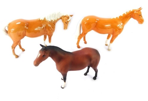 Three Beswick horse figures, comprising two palomino horses, 17cm and 15cm high, and a matt brown horse 13cm high. (3)