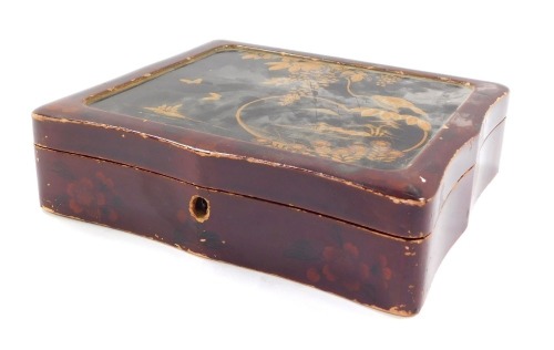 A Japanese lacquered box, with painted red lacquer detail and gilt highlight of birds, trees and butterflies, 6cm high, 22cm wide, 16cm deep.