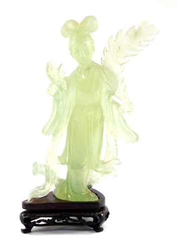 An early 20thC carved green quartz figure of Guanyin, modelled standing holding a leaf 19cm high, with ebonised base, boxed.