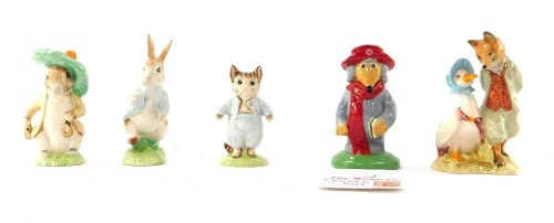 A group of figures, comprising a John Beswick Peter Rabbit with gold stamp, a Tom Kitten with gold stamp and a Benjamin Bunny with gold stamp, boxed, together with a Royal Albert Foxy Gent figure and a weighed Orinoco, boxed. (5)