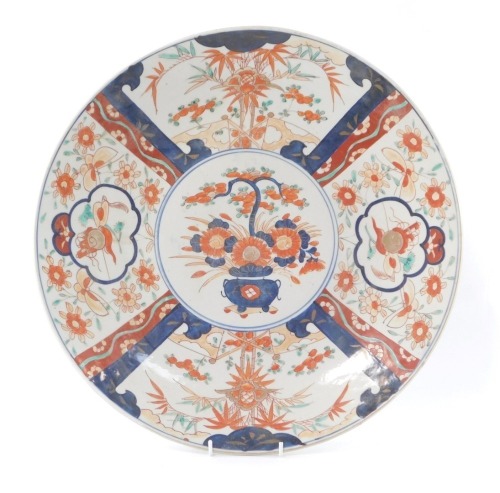 A 19thC Japanese Imari charger, decorated with five reserves of flowers and Buddhistic emblems, 46cm diameter.