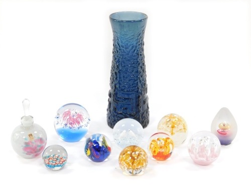 A group of art glass, comprising a Whitefriars style blue vase, 29cm high, a Mdina scent bottle and stopper, 15cm high, two Caithness paperweights and other unmarked paperweights. (a quantity)