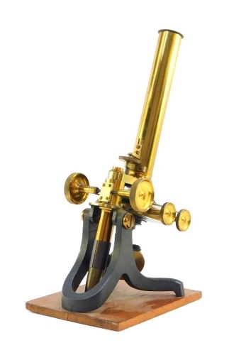 A 19thC brass microscope, on a wooden base, 31cm high.