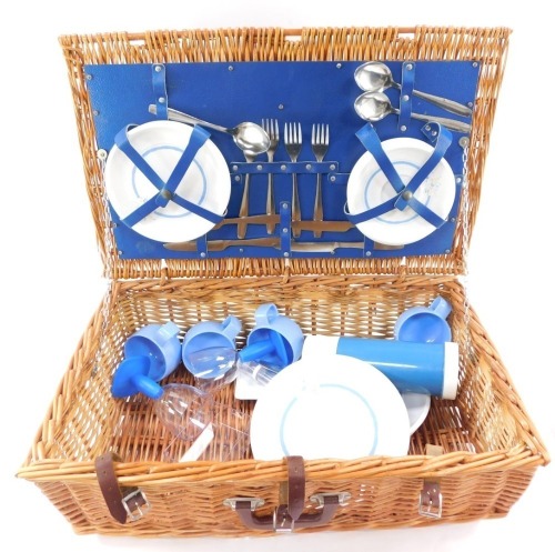 A 1970's/1980's picnic hamper, with contents of Brexton flask, and Melamine four place setting, etc, wicker basket with brown carry handle, 20cm high, 65cm wide, 40cm deep.