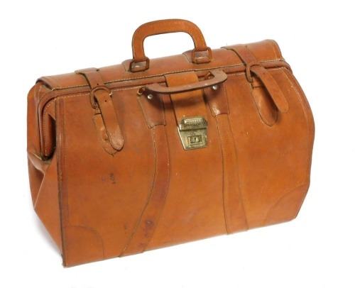 A tan leather Gladstone bag by CNABC.