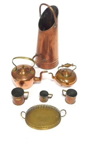 A group of copper and brass ware, comprising a copper coal scuttle, 60cm high, two copper kettles, 22cm high, two copper tankards, grain, and a brass serving tray. (7)