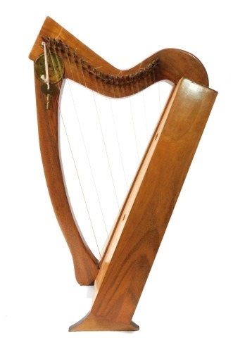 A modern table top harp, with stand, 65cm high, 29cm wide, 15cm deep.