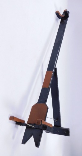 A black painted music stand, with tan leather supports, 92cm high.